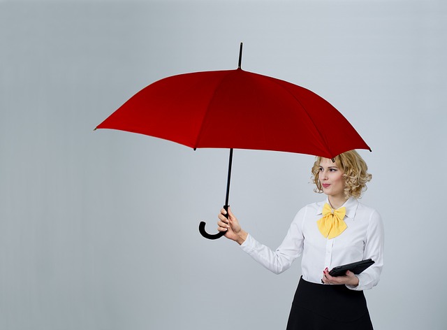 A woman with an umbrella, signifying how a condo association bad faith lawyer can help secure insurance payments.